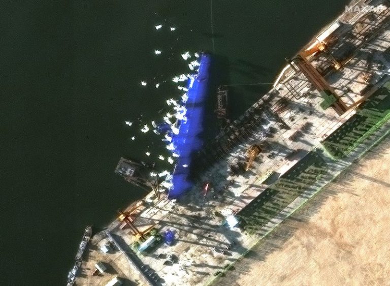North Korea arrests four over failed warship launch as images show vessel shielded from prying eyes